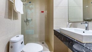 A modern bathroom with a toilet, sink, and shower. - Tianhu Hotel (Nanjing)