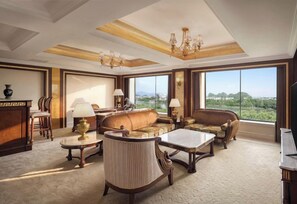 A spacious living room with a large window, a sofa set, a coffee table, and a chandelier. - Sheraton Guilin Hotel (Guilin)