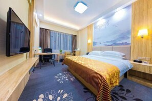 A hotel room with a bed, desk, chair, television, and a wall-mounted TV. - Landscape Hotel (Longyan Railway Station) (Longyan)