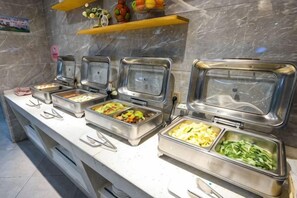 A buffet with multiple food service stations, each with a covered serving area. - Landscape Hotel (Longyan Railway Station) (Longyan)
