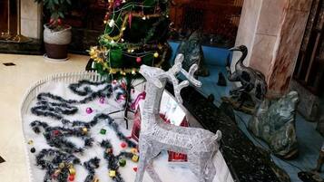 A Christmas tree with ornaments and a reindeer decoration.