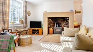 A cozy living room with a fireplace, a television, and comfortable seating. - 1 bedroom accommodation in Durham (Durham)