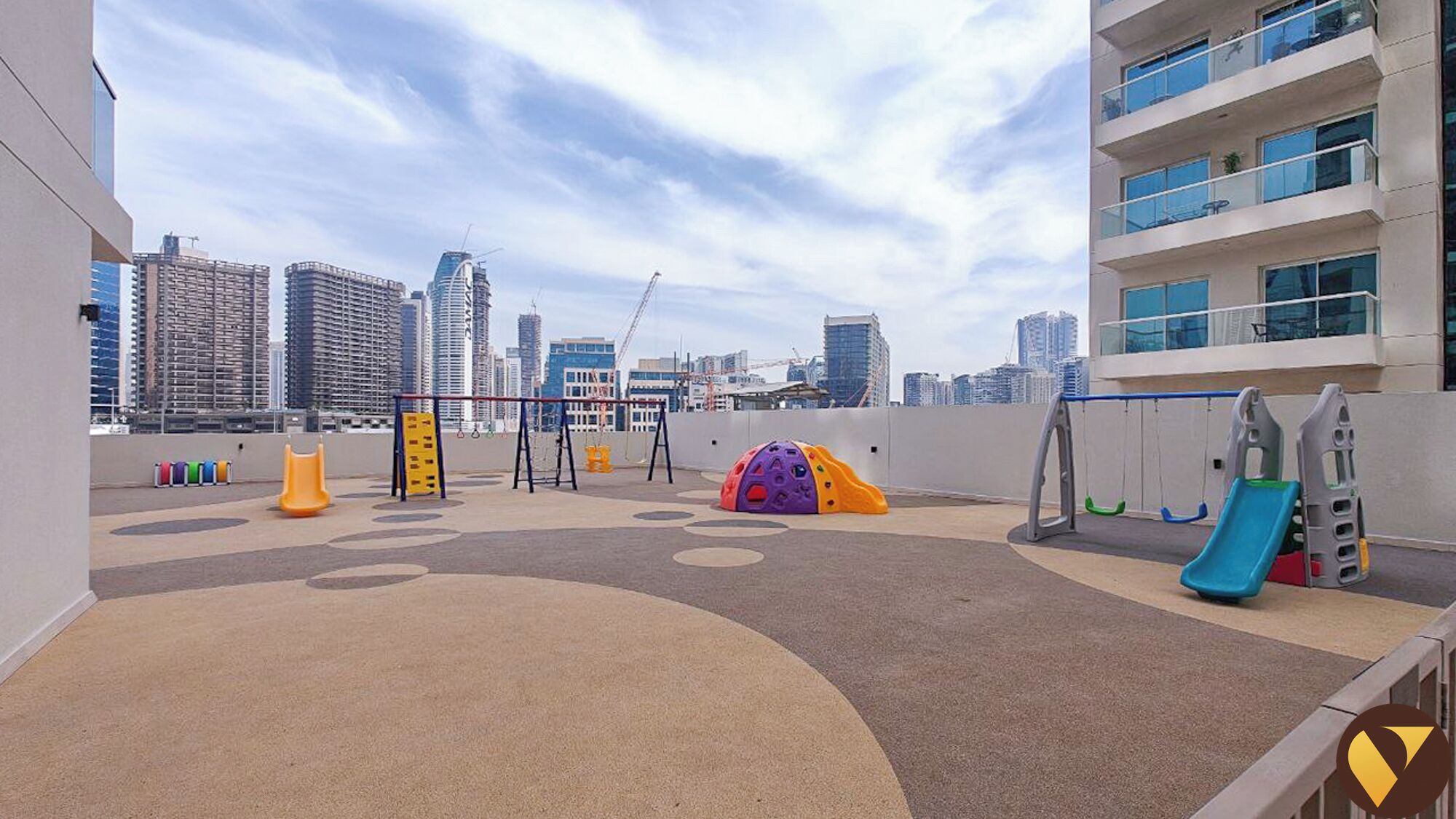 A rooftop playground with play structures, a slide, and a climbing net.