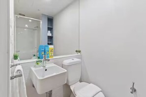 Bathroom features a sink, toilet, and mirror.