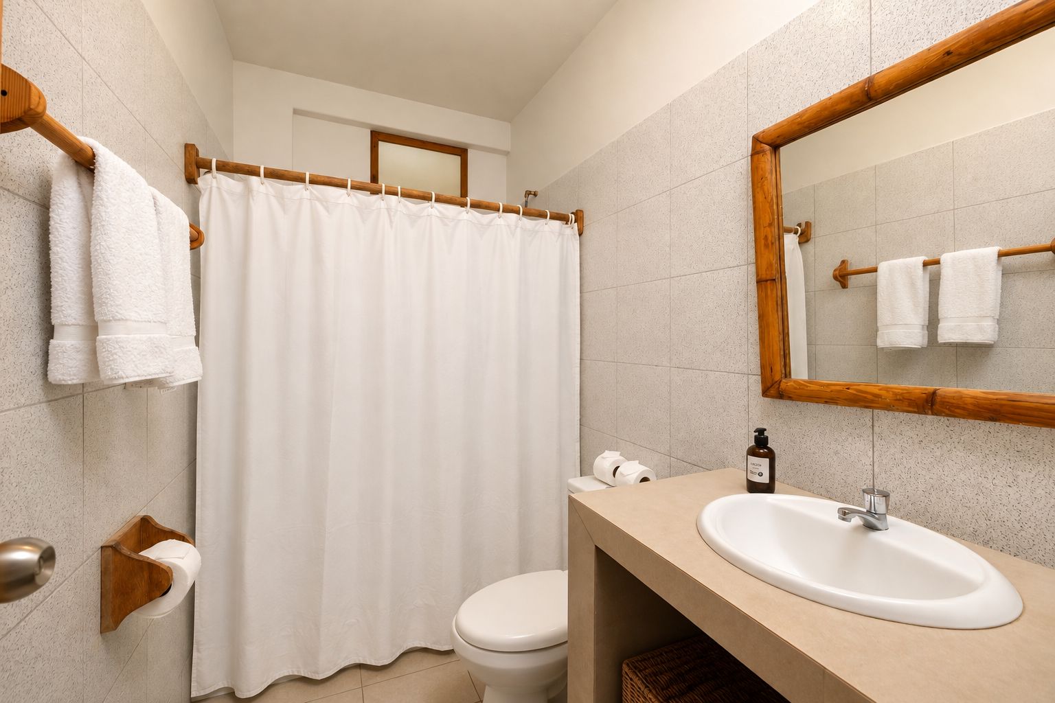 A bathroom with a shower curtain, a toilet, a sink, and a mirror.