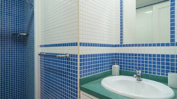 Shower, hair dryer, towels, toilet paper