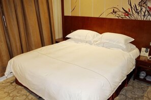 A neatly made bed with white linens in a hotel room. - Lidu Boutique Hotel (Shanghai)