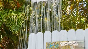 A white fence with a sign that reads "Cool at the Pool" and a showerhead above it. - Miami Pool Cottage in El Portal (Miami)
