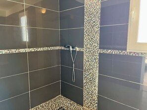 Een douche, handdoeken, toiletpapier