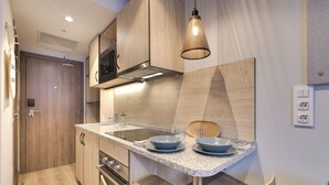 A modern kitchen with wooden cabinets, a stainless steel sink, and a pendant light. - Livensa Living Salamanca Parking Free (Salamanca)