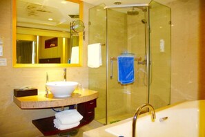A modern bathroom with a glass-enclosed shower, a white sink, and a large bathtub.