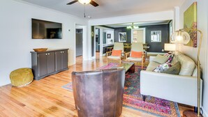 A spacious living area with a ceiling fan, a sofa, a coffee table, and a patterned rug. - Bike, Hike & Unwind at Doodle Trailside Retreat (Pickens)