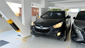 A parking garage with two cars parked side by side. - Brisa de Palmas - Res. Maria Eduarda (Governador Celso Ramos)