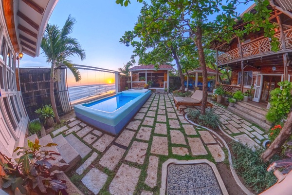 The Beach House Goldern Hour. Our sunsets are undefeated. Come see it in real life sitting our our his and her swings overlooking the rolling waves.