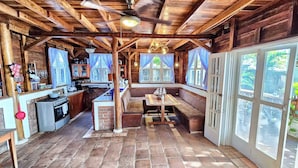 A rustic cabin with a kitchen, dining area, and large windows. - 2 Beachfront casitas for 8 w Pool & AC, Wifi (Pochomil)