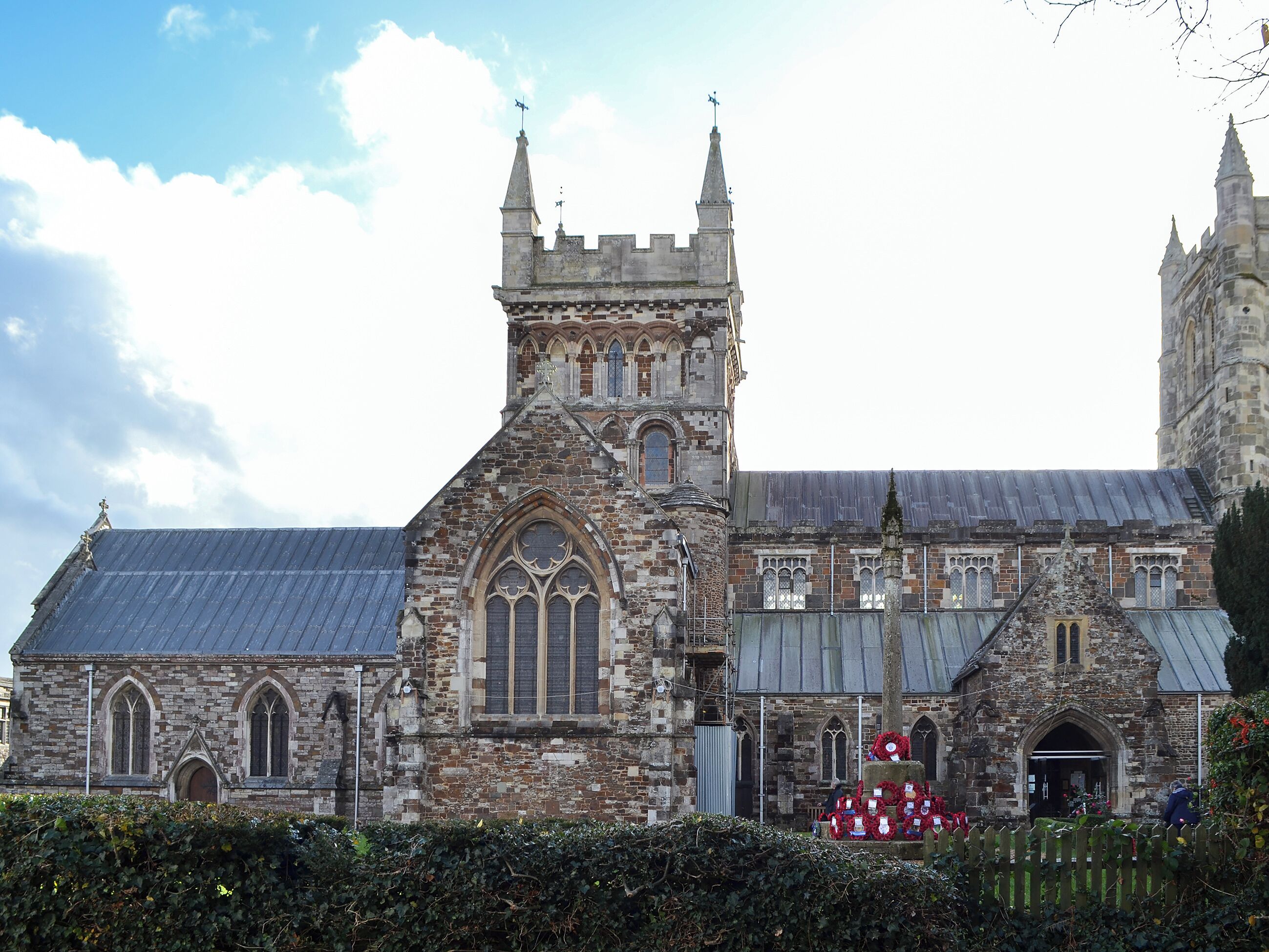 A historic church with a large central tower, arched windows, and a stone facade.