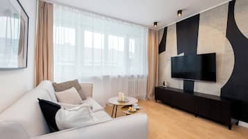 Deluxe Apartment, Balcony, City View | Living area | 50-inch Smart TV with cable channels, Netflix, streaming services