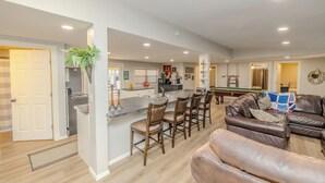 A spacious living area with a central island, a pool table, and a leather sofa. - Spacious 6-bedroom house in enjoyable PK with Waterfront Access Near Rocker-B (Graford)