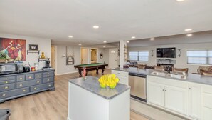 A spacious living area with a pool table, a kitchen with a dishwasher, and a dining area with a TV. - Spacious 6-bedroom house in enjoyable PK with Waterfront Access Near Rocker-B (Graford)