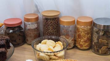 A variety of food items in jars and a bowl on a table.
