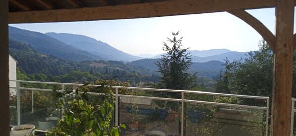 A balcony with a view of a mountainous landscape.