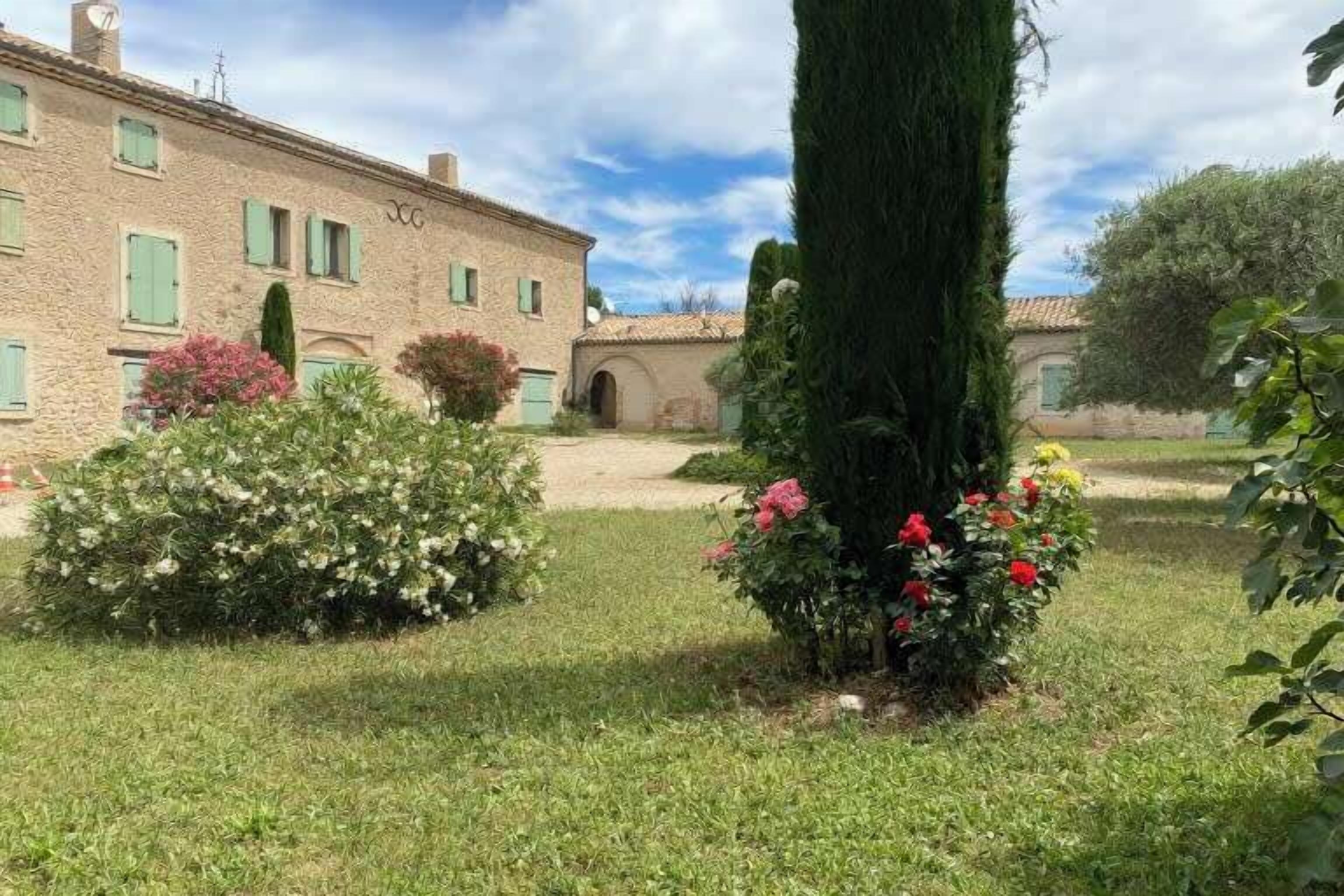 A stone building with a garden in front.