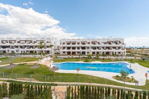 A modern hotel with a large swimming pool, multiple balconies, and a well-maintained garden area. - Apartamento Vamos (Mar de Pulpi) (San Juan de los terreros)