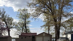 A rural property with a gravel driveway, a garage, and a boat docked outside. - Finch House on Lake Osakis: Charming 2-bedroom cabin (Osakis)