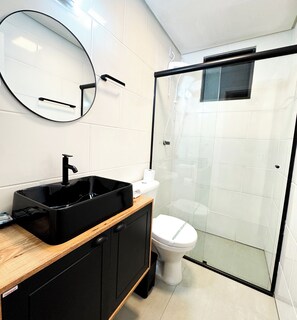 Bathroom features a sink, toilet, and shower enclosure.