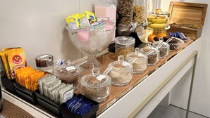 A buffet setup with various food items and beverages. - Hotel São José (Sao Jose)
