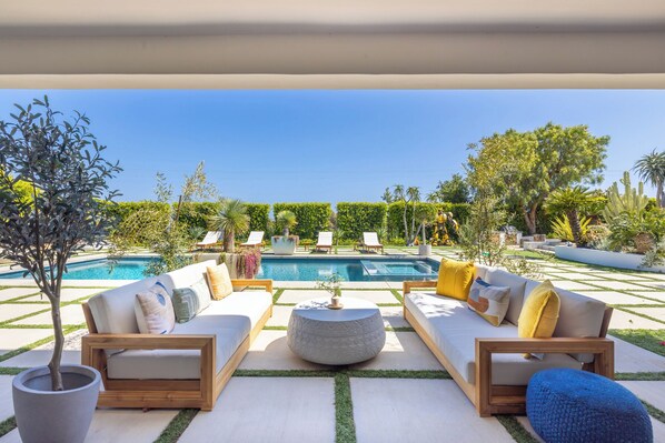 Outdoor pool, open 6:00 AM to 10:00 PM, pool loungers