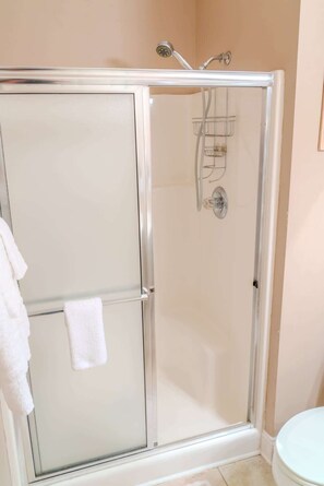 Shower, hair dryer, towels, shampoo
