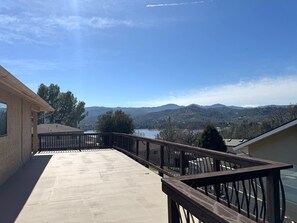 A balcony with a view of a lake and mountains.