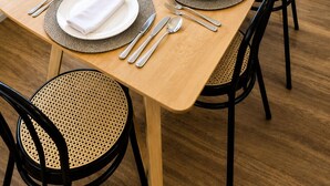 A dining table set for six with a view of the ocean. - Cronulla Ocean View, Steps to Beach (Cronulla)