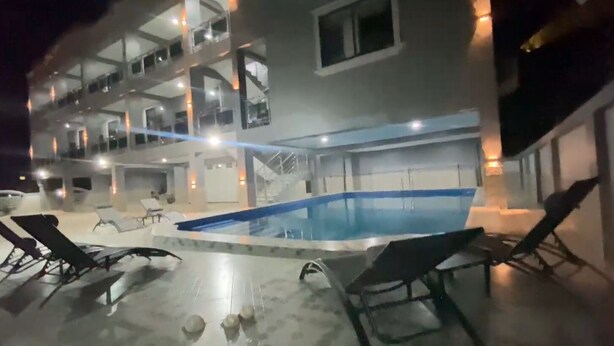 A multi-story building with a swimming pool and lounge chairs. - DJ Villa Your Premium Stay-NF12 (Dawhenya)