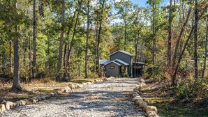 A gravel path leading to a cabin surrounded by trees. - Silent Princess, Tiny Home (Tracy City)