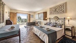 A bedroom with a bed, a chair, a small table, and a window. - Rustic Retreat with Pool and Stunning Views (Altura)