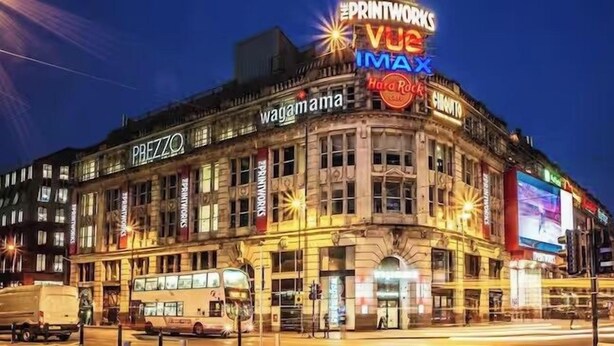 A historic building with multiple commercial signs, including "PREZZO" and "wagamama". - Not available (Salford)