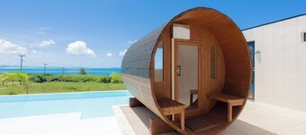 A private villa with a pool jacuzzi and sauna overlooking the ocean from a high vantage point / Miyakojima Okinawa