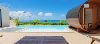 A private villa with a pool jacuzzi and sauna overlooking the ocean from a high vantage point / Miyakojima Okinawa