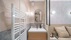 A modern bathroom with a white vanity, a mirror, and a shower area. - Mabulle Originality & Comfort in the Dijon's Heart (Dijon)