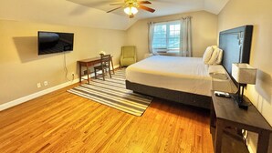 A bedroom with a bed, a desk, a chair, a television, a ceiling fan, and a window with curtains. - 4BR Home BoA, Discovery, Raptor, USNWC & Uptown (Charlotte)