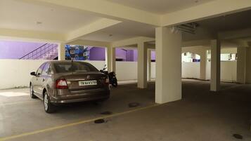A parking garage with a car parked in a designated space.