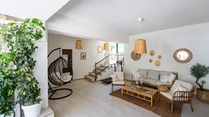 A spacious living area with a hanging chair, a sofa set, a coffee table, and a staircase leading to an upper level. - Villa Kate - Dubrovnik by Villas Guide (Dubrovnik)