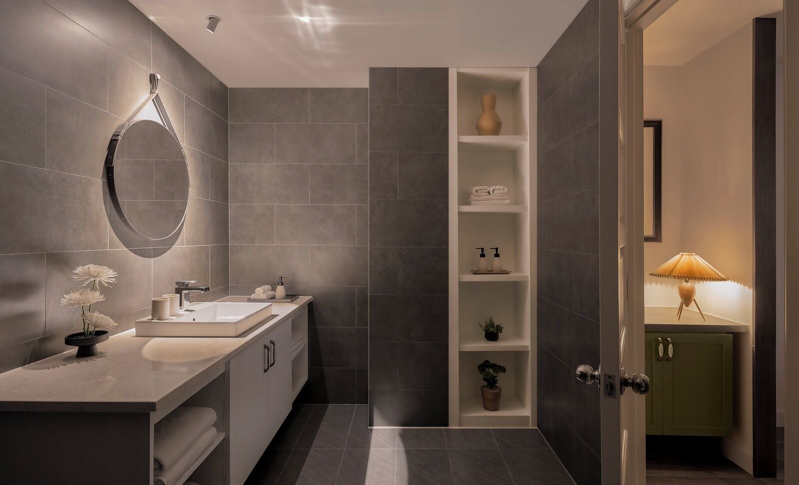 A modern bathroom with a vanity, a mirror, and a shelf with toiletries.