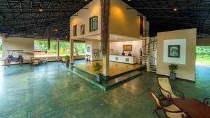 A spacious lobby with a high ceiling, a reception desk, seating area, and a staircase. - Kassapa Lion Rock  (Sigiriya)