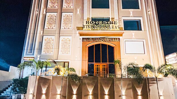 A hotel with a grand entrance, multiple floors, and decorative patterns on the facade. - Hotel The Rising Banaras (Varanasi)