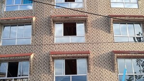 A multi-story building with a brick facade and multiple windows. - Hotel Valley View by Ravongla Star (Gyalshing)