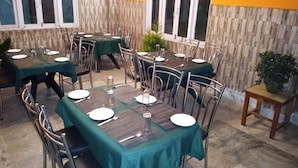 A restaurant with multiple tables set for dining, each with chairs and table settings. - Hotel Valley View by Ravongla Star (Gyalshing)