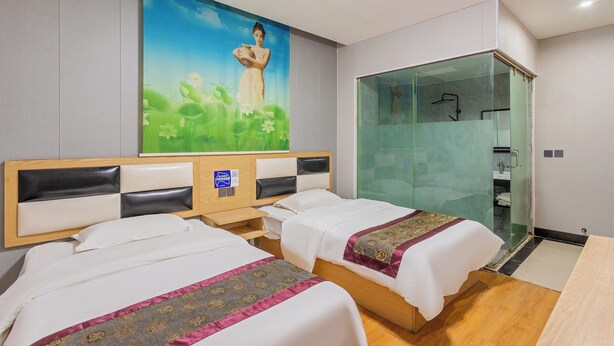 A hotel room with two beds, a mural on the wall, a glass-enclosed shower area, and a wooden floor. - Kunming Panju Hotel (Kunming)